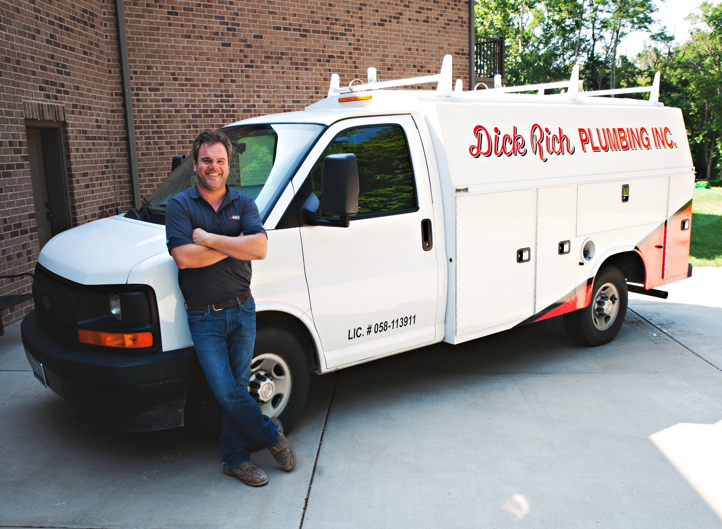 Dick Rich Plumbing plumber standing beside a company service van in Washington, IL